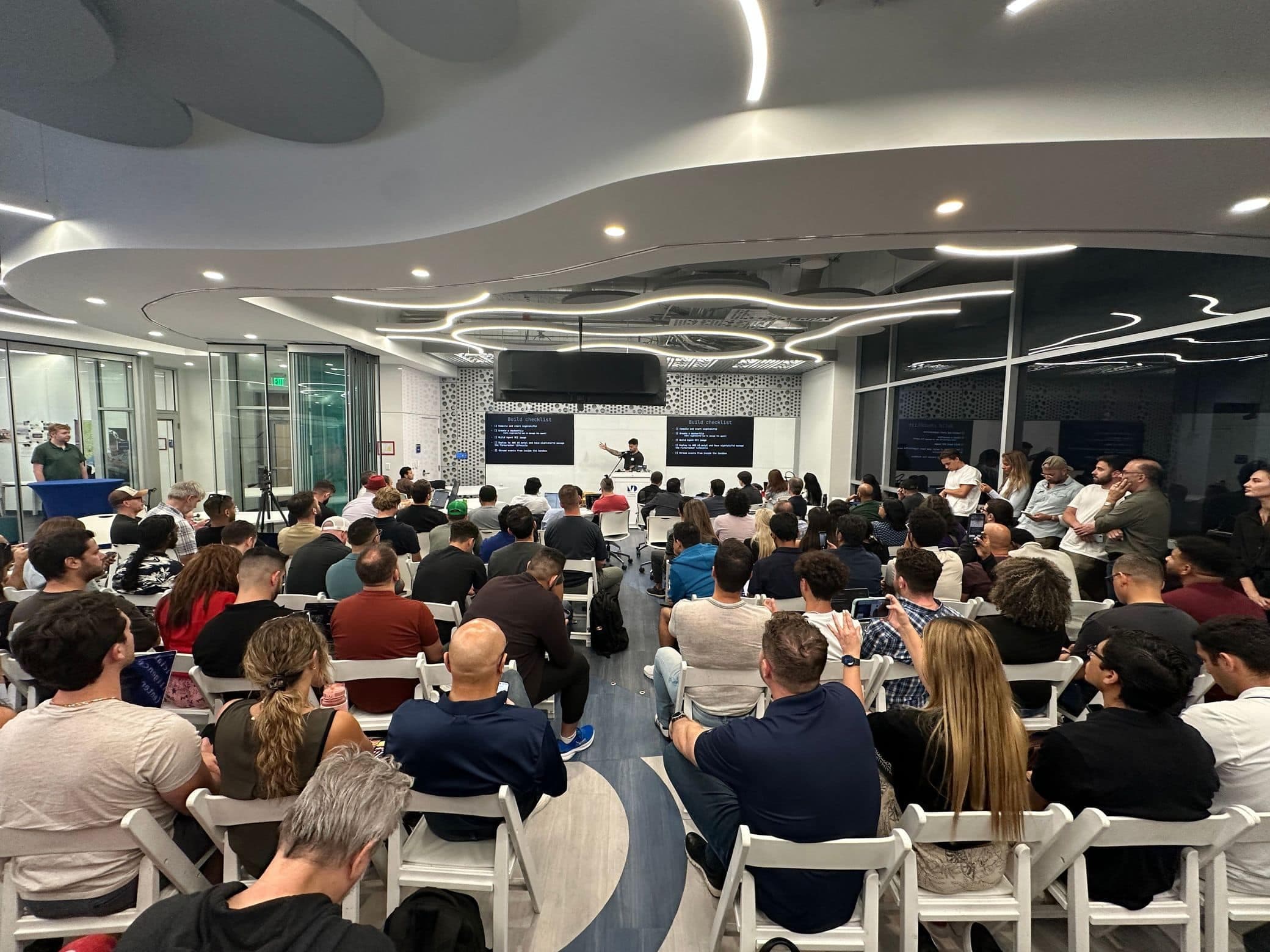 A packed room follows a talk at the AI Center